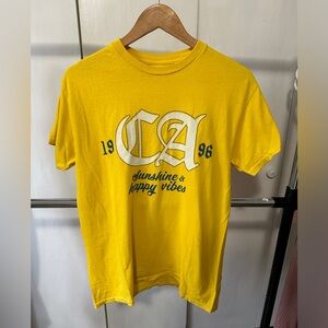 Yellow graphic tee.